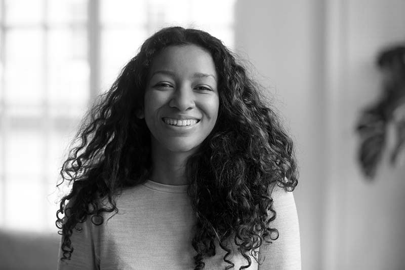 young woman with beautiful smile and curly hair