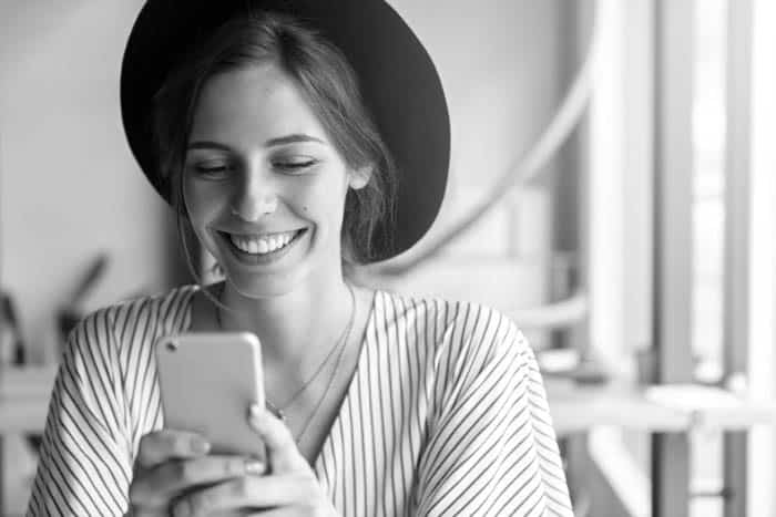 Fair Lakes Family Cosmetic Dentistry Happy Woman On Cellphone root canal