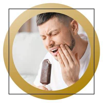 man cringing after bite of ice cream